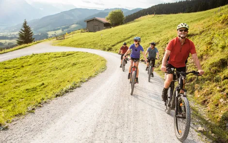 'Good Life' bike weeks Group of cyclists riding mountain bikes on a gravel path through scenic countryside